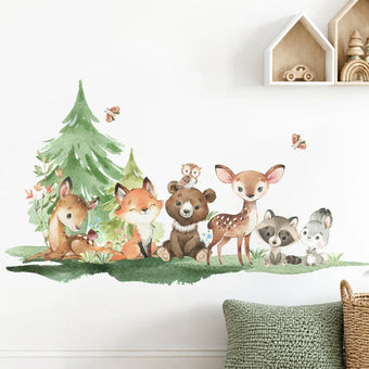 Enchanted forest pack – woodland animals wall sticker with a fox, bear cub and fawn above a sage knitted cushion and a rattan basket