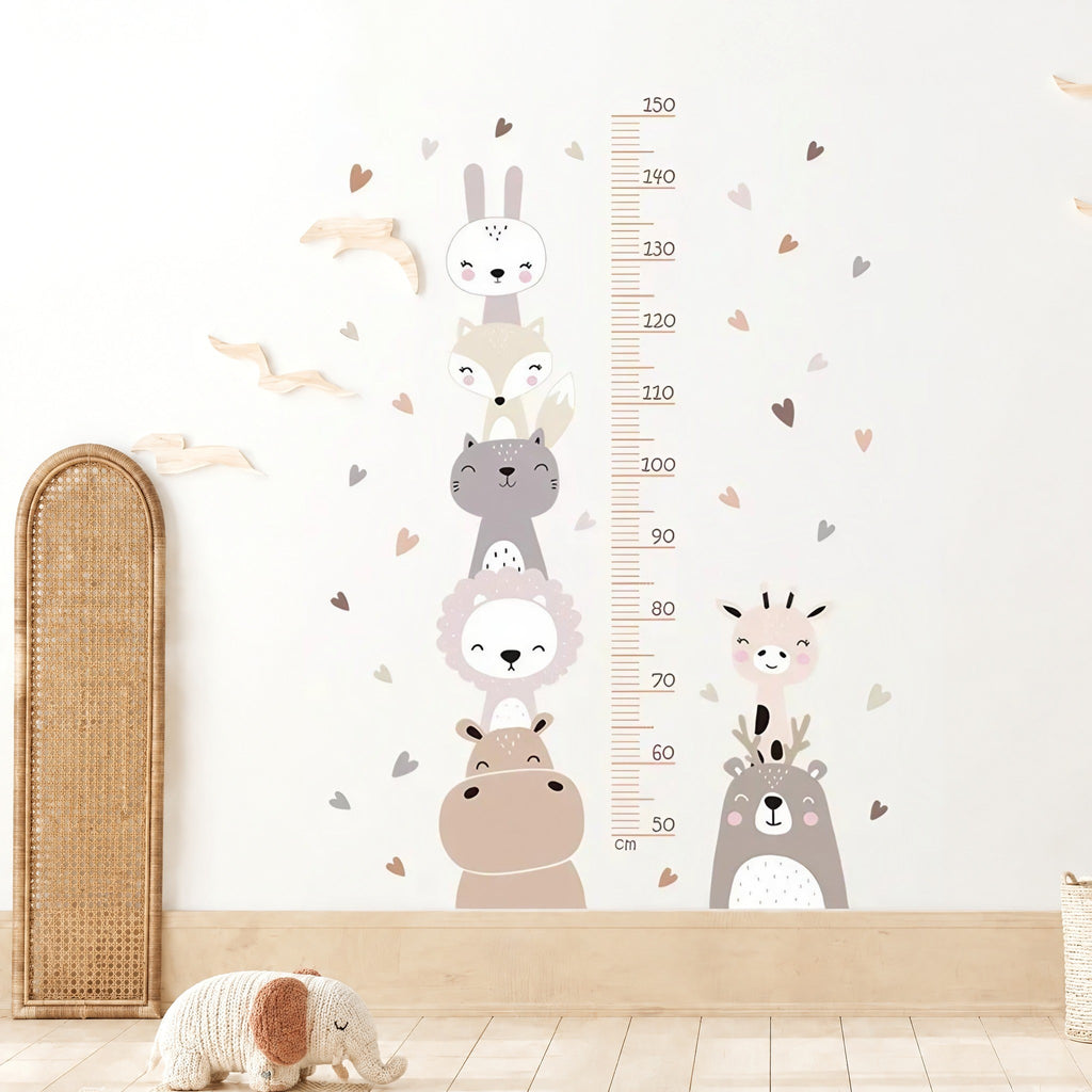 Toise murale animaux empilés et petits cœurs nude au-dessus d'une plinthe en bois, à côté d'un panneau en cannage